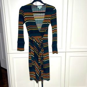 Veronica M.  Beautiful Wrap Dress.  Very flattering!!